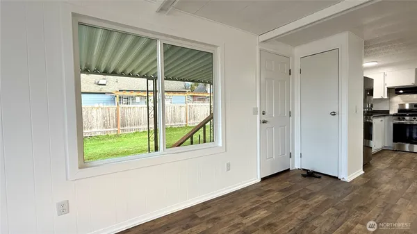 an empty room with wooden floor and a window