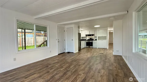 a view of a kitchen with a sink a refrigerator and window