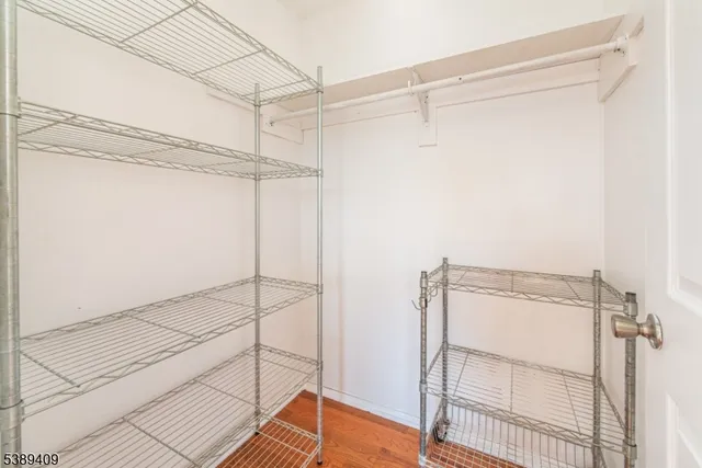 a view of a room with wooden floor and cabinet