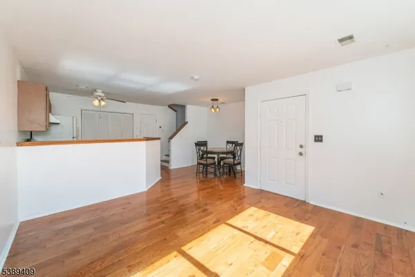 a view of kitchen and dining room with wooden floor