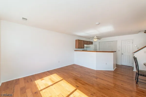 a kitchen with cabinets and wooden floor