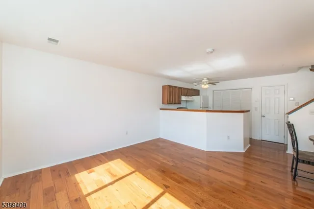 a kitchen with cabinets and wooden floor