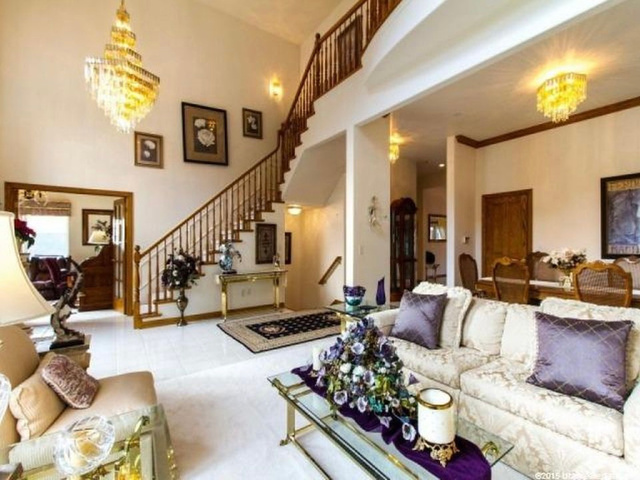 1085 Windsor Drive Provo, UT 84604 - Photo 16 of 83 Living area with a chandelier, a towering ceiling, and stairway