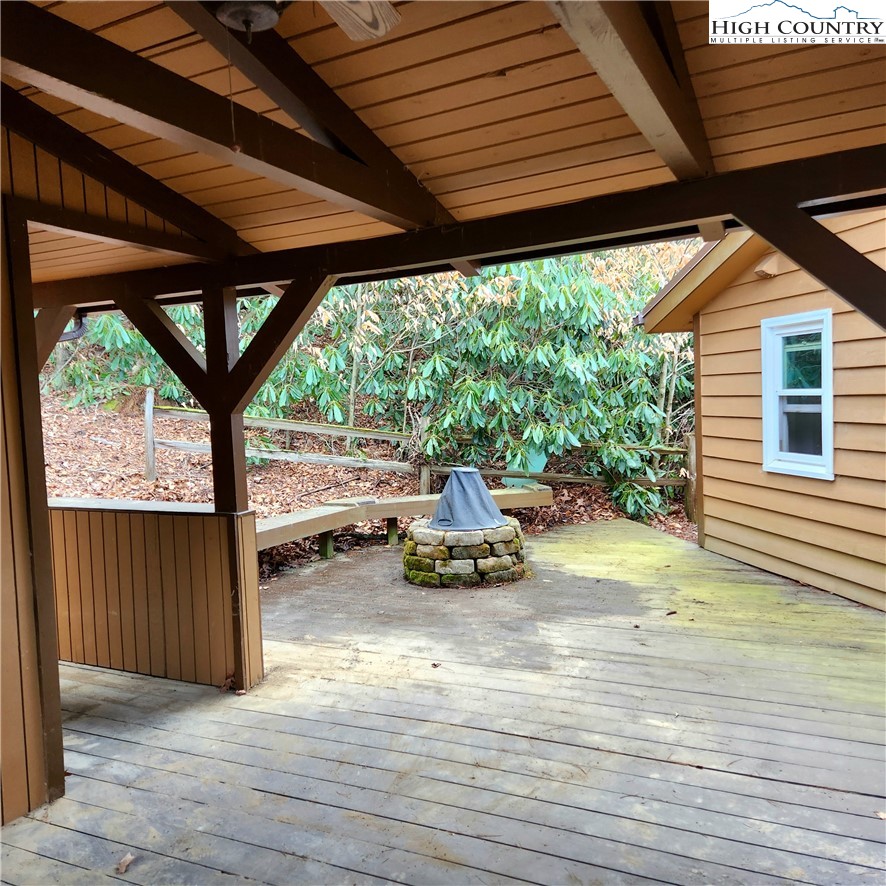 58 River Road Newland, NC 28657 - Photo 16 of 28 a view of a patio with table and chairs under an umbrella