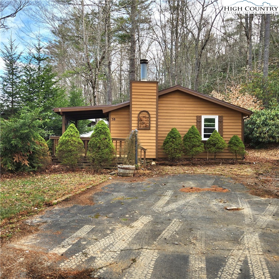 58 River Road Newland, NC 28657 - Photo 2 of 28 a view of a house with a yard and large tree