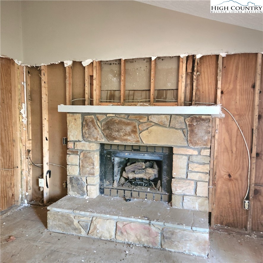 58 River Road Newland, NC 28657 - Photo 7 of 28 a living room with furniture a fireplace and a kitchen view