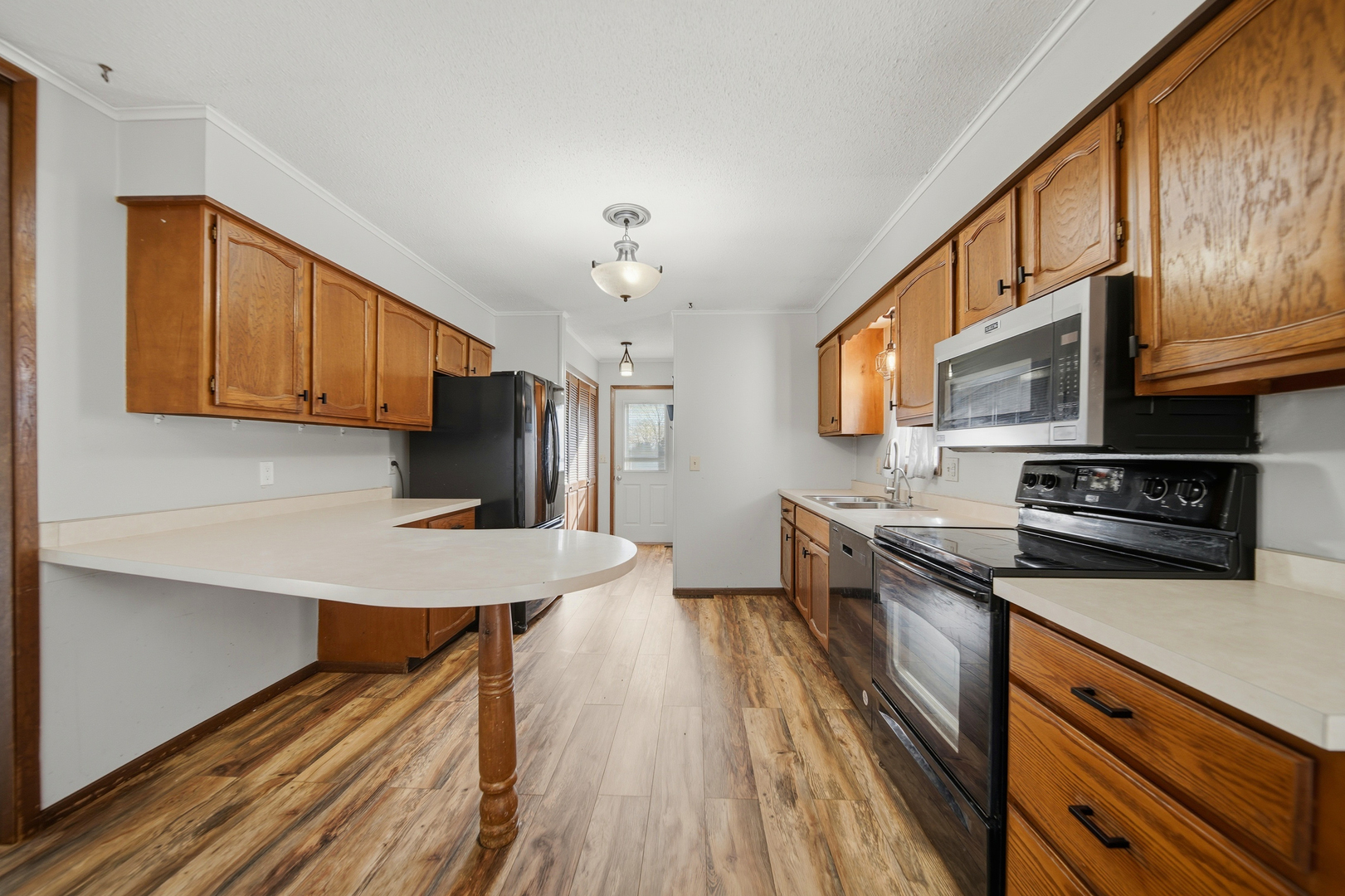 13831 Prairie Center Road Morrison, IL 61270 - Photo 11 of 32 a kitchen with stainless steel appliances a stove microwave and refrigerator