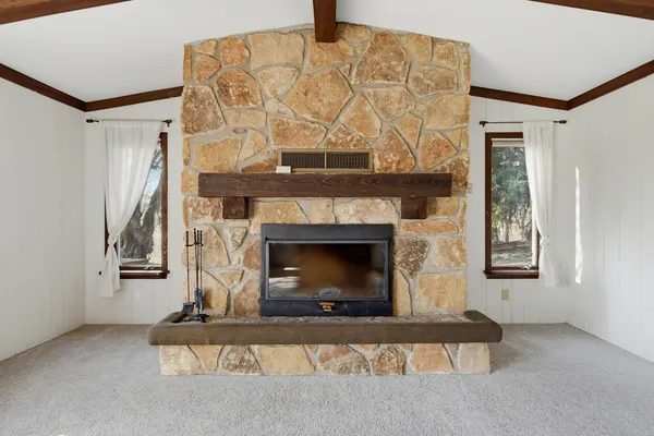 a living room with a fireplace and a wooden floor