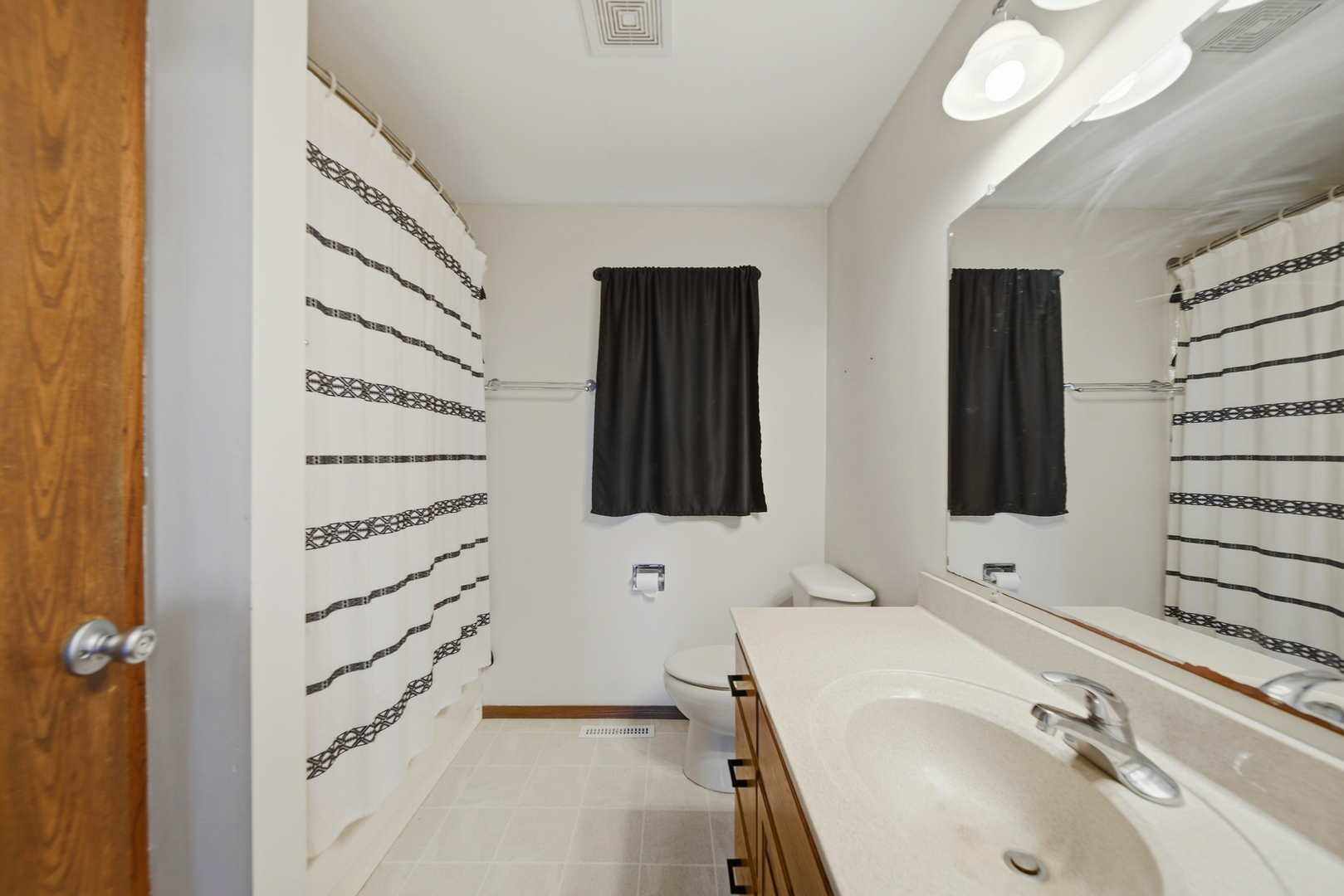 13831 Prairie Center Road Morrison, IL 61270 - Photo 16 of 32 a bathroom with a sink and a mirror