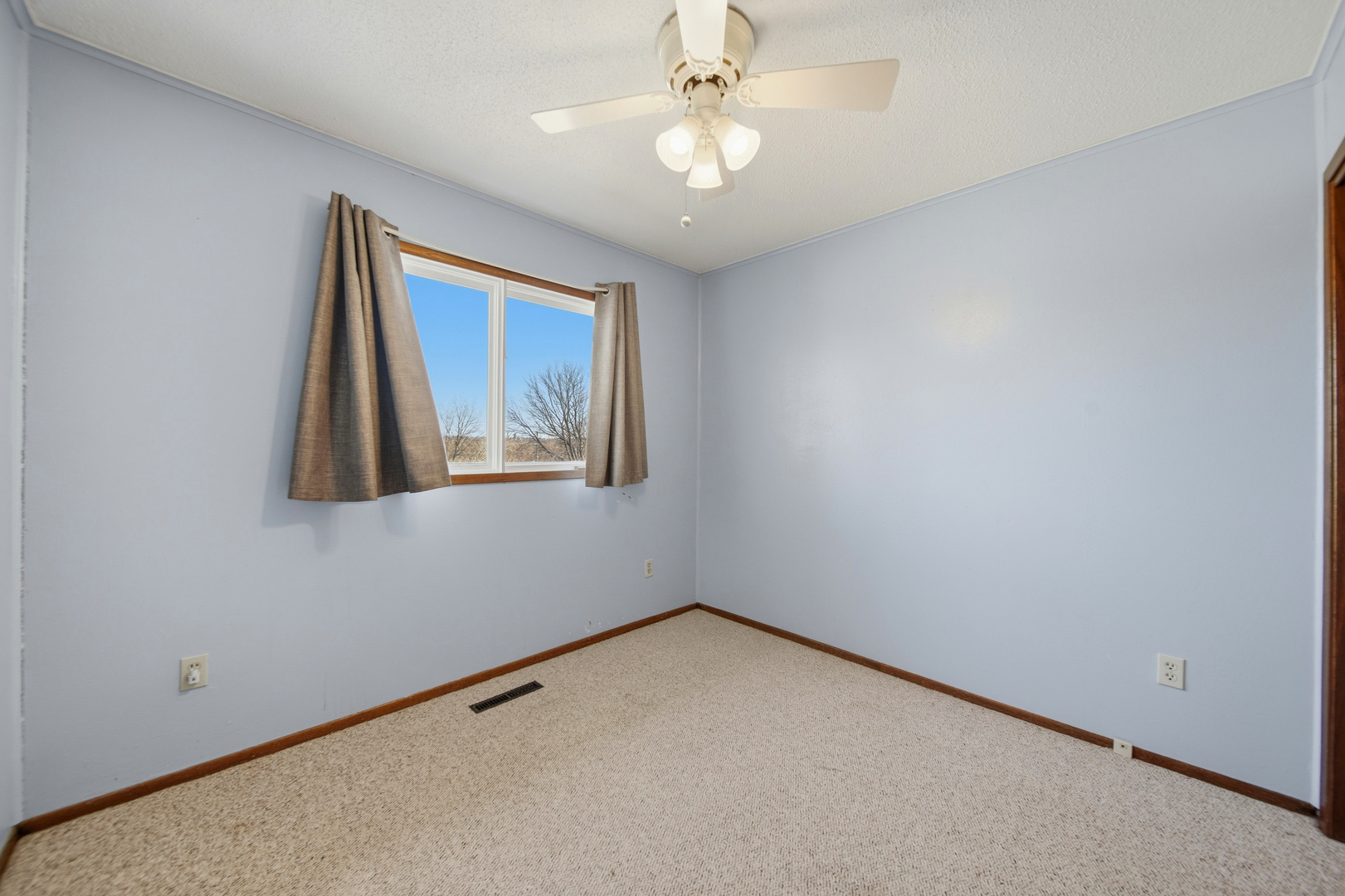 13831 Prairie Center Road Morrison, IL 61270 - Photo 18 of 32 an empty room with windows and fan