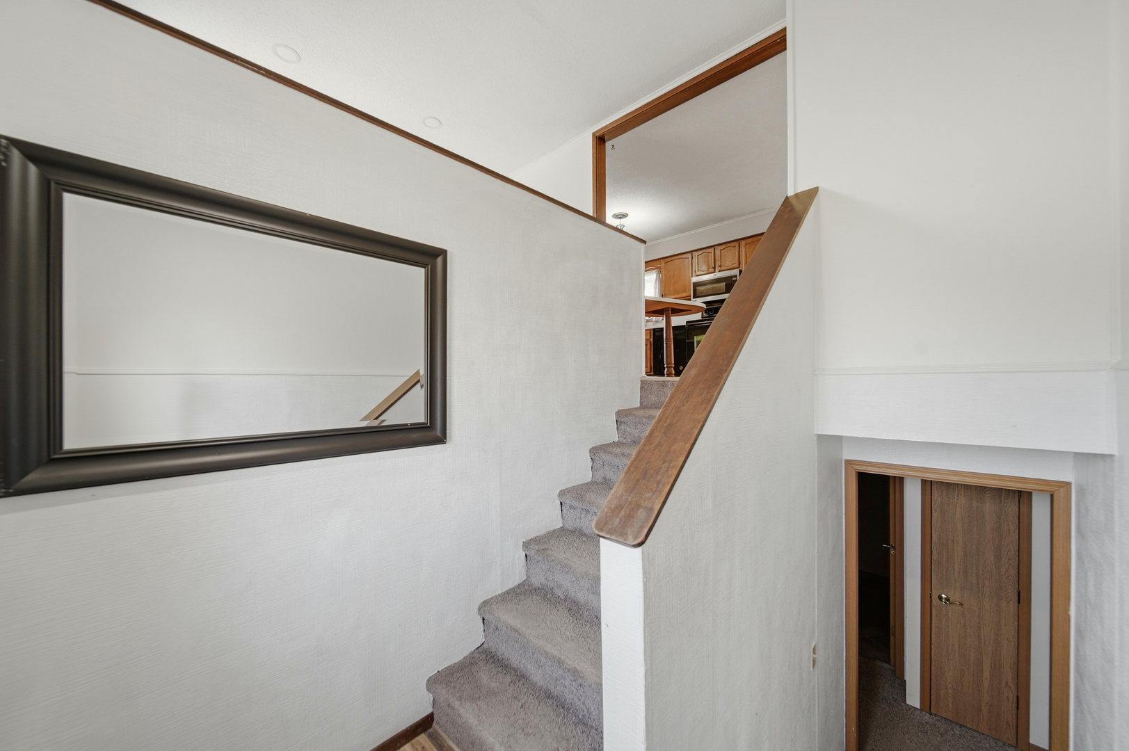 13831 Prairie Center Road Morrison, IL 61270 - Photo 20 of 32 a view of staircase with wooden floor and a front door