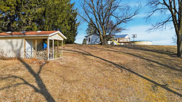 a view of a yard with wooden fence