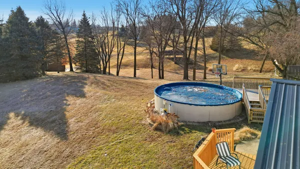 a view of a swimming pool with a backyard and trees