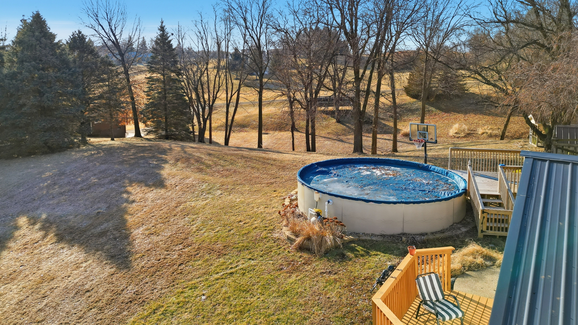 13831 Prairie Center Road Morrison, IL 61270 - Photo 4 of 32 a view of a swimming pool with a backyard and trees