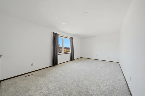 a view of an empty room and stove