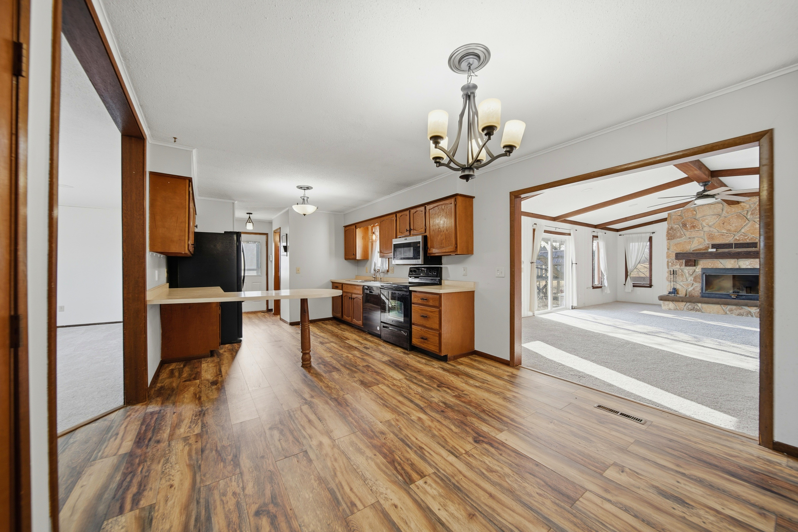 13831 Prairie Center Road Morrison, IL 61270 - Photo 10 of 32 a view of a living room and kitchen with furniture wooden floor and window