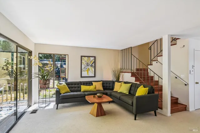 a living room with furniture and a floor to ceiling window