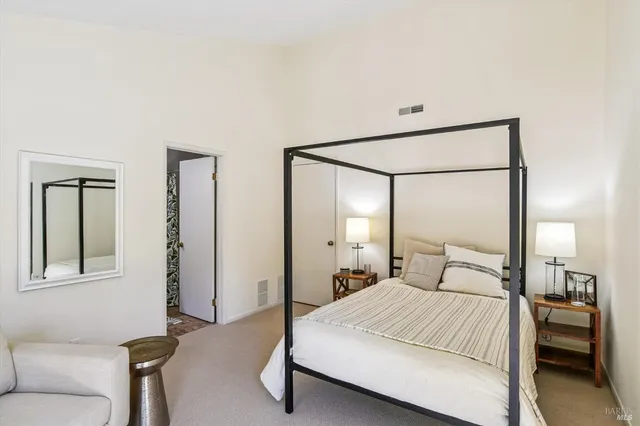 a bedroom with a bed and a mirror