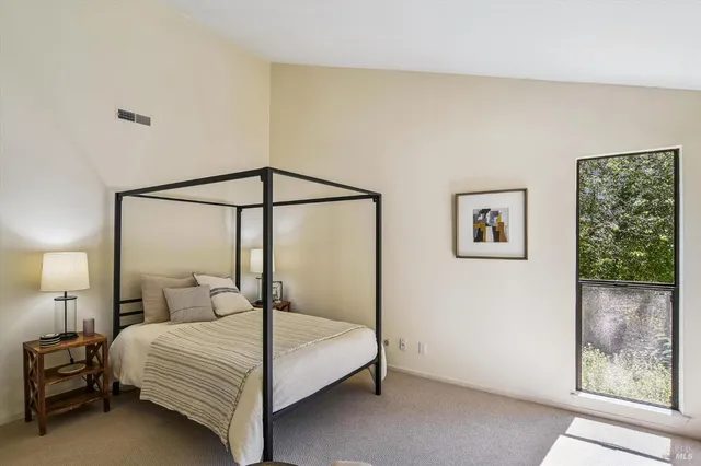 a bedroom with a bed and large mirror