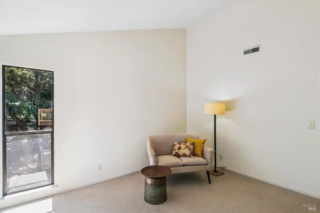 a living room with furniture a lamp and a window
