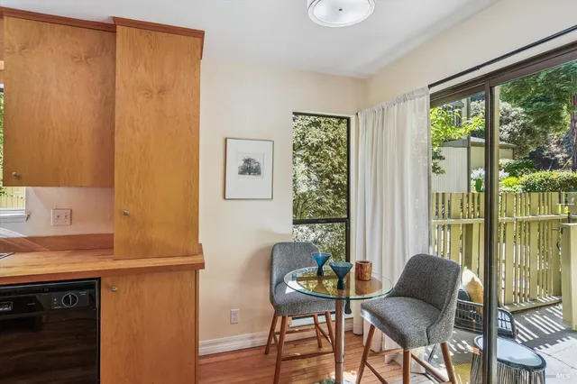 a view of a room that has a window and furniture