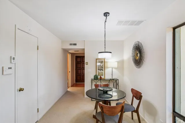 a view of a room with a table and chairs
