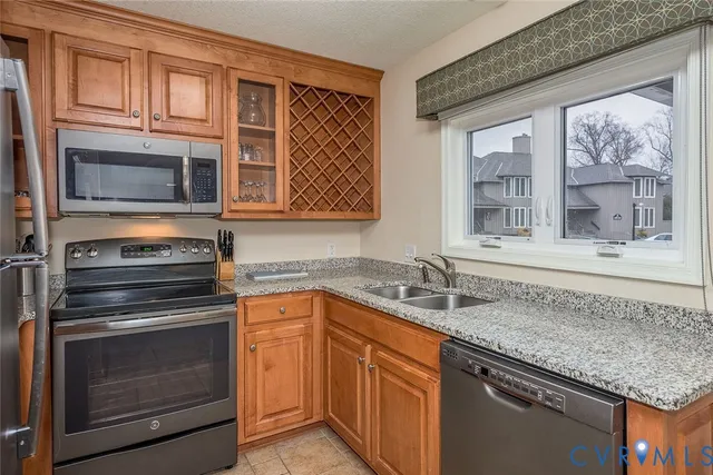 a kitchen with stainless steel appliances granite countertop stove microwave and sink