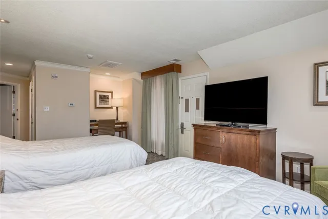 a bedroom with a flat screen tv and a bed