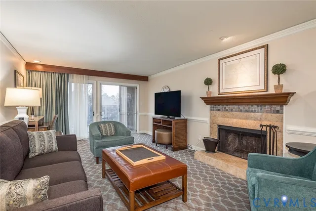 a living room with furniture a flat screen tv and a fireplace