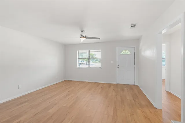 wooden floor in an empty room with a window