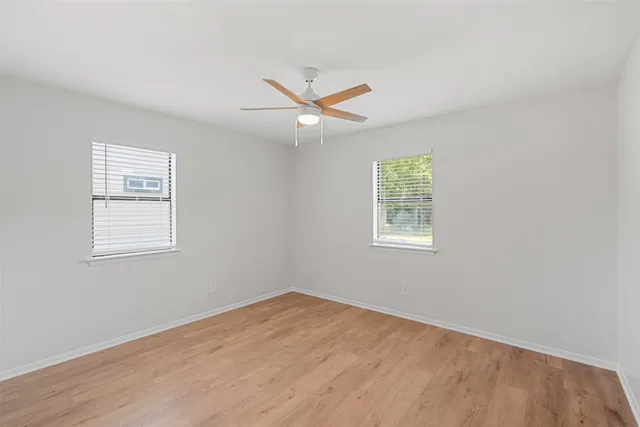 wooden floor in an empty room with a window