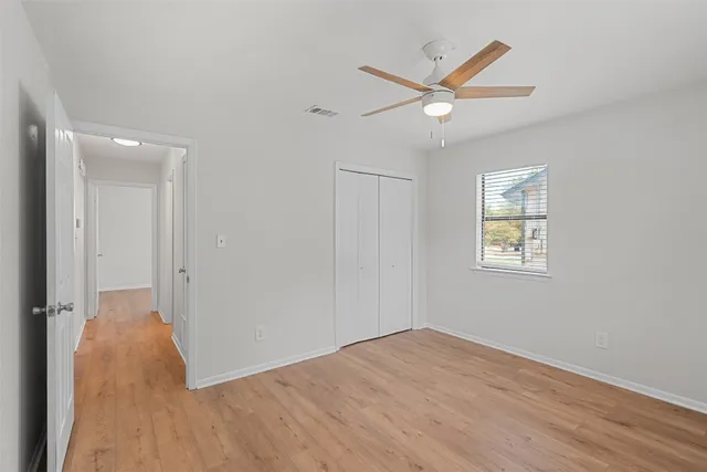 wooden floor in an empty room with a window