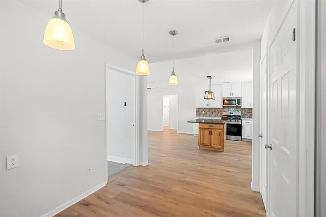 a kitchen with stainless steel appliances a refrigerator and a stove top oven