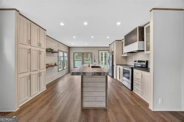 a kitchen with white cabinets and appliances