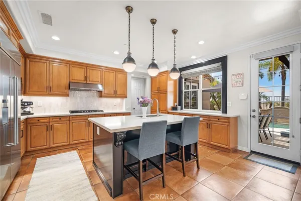 a kitchen with a table chairs sink and cabinets