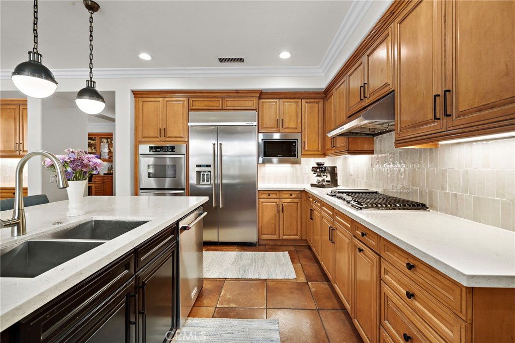 8 Ranunculus Street Ladera Ranch, CA 92694 - Photo 15 of 39 a kitchen with stainless steel appliances granite countertop a sink a stove and a refrigerator