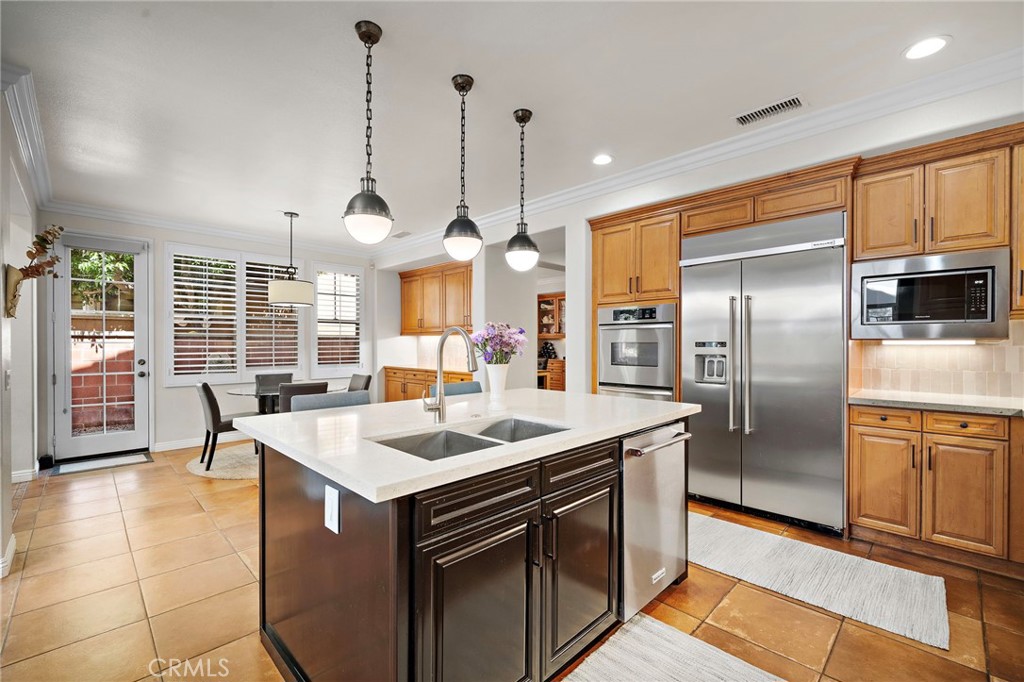 8 Ranunculus Street Ladera Ranch, CA 92694 - Photo 16 of 39 a kitchen with stainless steel appliances granite countertop a sink a stove and a refrigerator