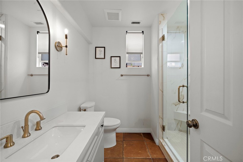 8 Ranunculus Street Ladera Ranch, CA 92694 - Photo 19 of 39 a bathroom with a sink and mirror with toilet