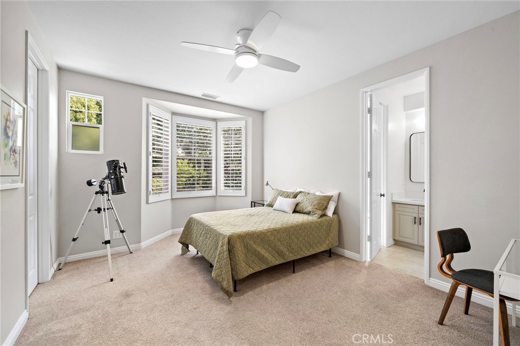 8 Ranunculus Street Ladera Ranch, CA 92694 - Photo 21 of 39 a bedroom with a bed and a table in it