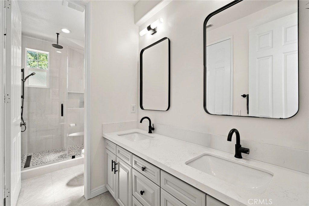 8 Ranunculus Street Ladera Ranch, CA 92694 - Photo 23 of 39 a bathroom with double vanity sinks and a bathtub