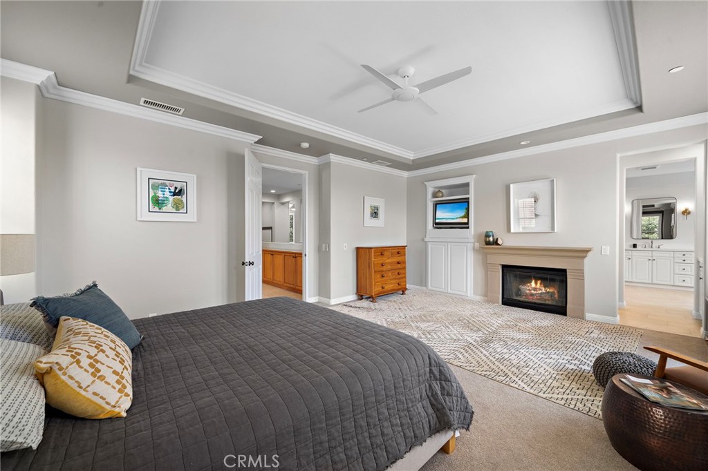 8 Ranunculus Street Ladera Ranch, CA 92694 - Photo 28 of 39 a spacious bedroom with a bed and fireplace