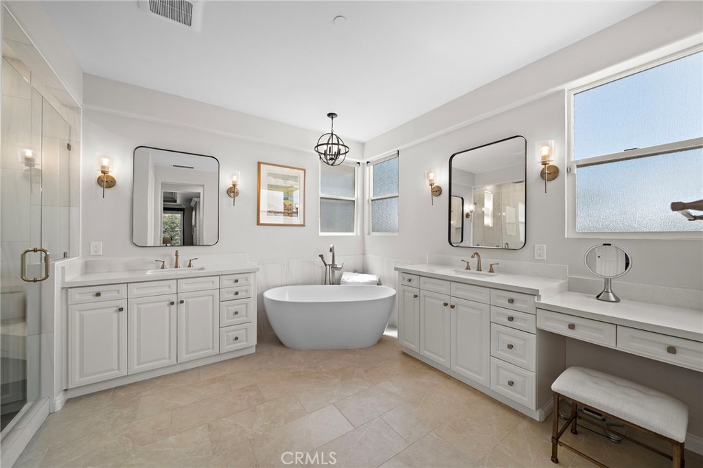 8 Ranunculus Street Ladera Ranch, CA 92694 - Photo 30 of 39 a spacious bathroom with a granite countertop sink mirror and bathtub