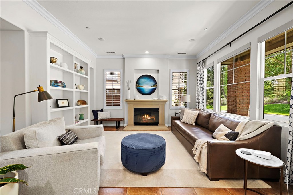 8 Ranunculus Street Ladera Ranch, CA 92694 - Photo 10 of 39 a living room with furniture a fireplace and a large window