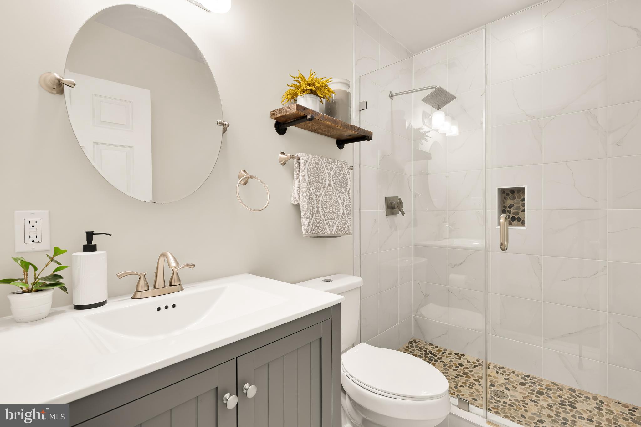 29 Q Street Northeast, Unit 2 Washington, DC 20002 - Photo 11 of 22 a bathroom with a sink a toilet and shower