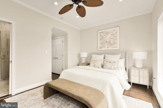 a bedroom with a bed painted wall with a large mirror