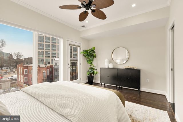 a bedroom with bed and a chandelier