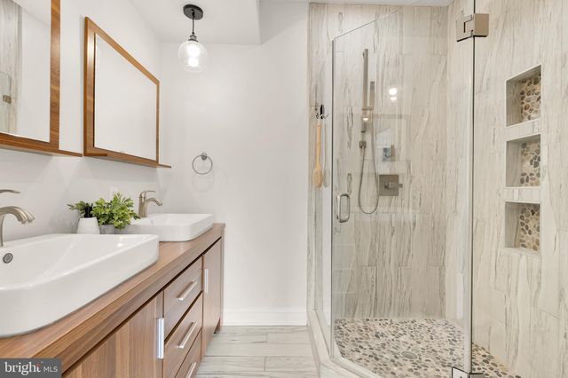 a bath room with a sink and a mirror