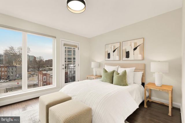 a bedroom with a large bed and a large window