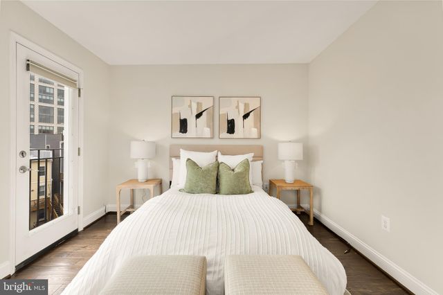 a bedroom with a bed and painting on the wall