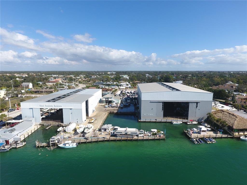 100 Circuit Road, Unit N77 Nokomis, FL 34275 - Photo 2 of 12 a front view of a house with a garden and yard